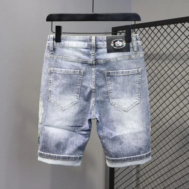 Blue denim shorts on a hanger against a gray background