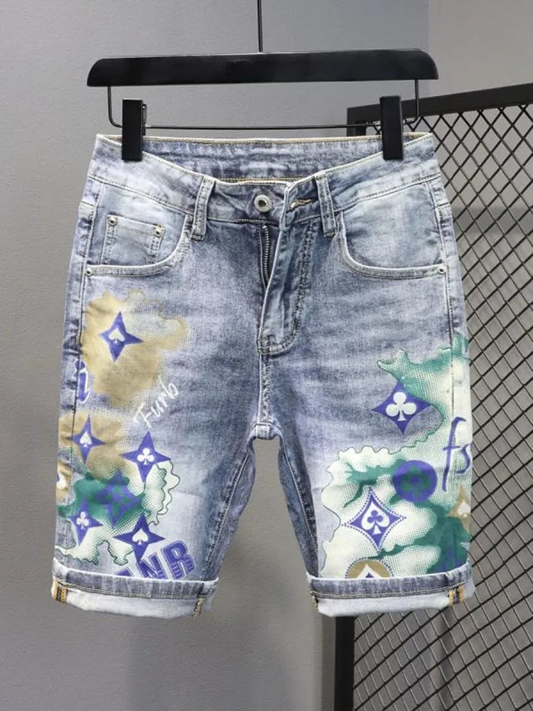 Denim shorts with floral and logo pattern on a hanger against a gray background
