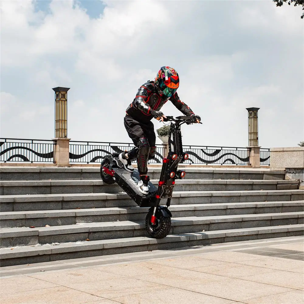 Person riding a scooter on stone steps with a scenic background