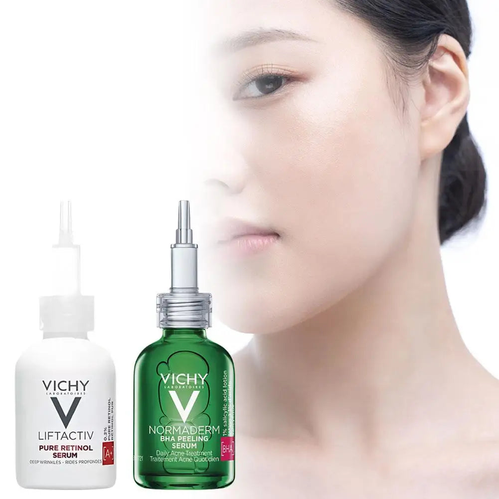 Vichy skincare serum bottles with a blurred face in the background