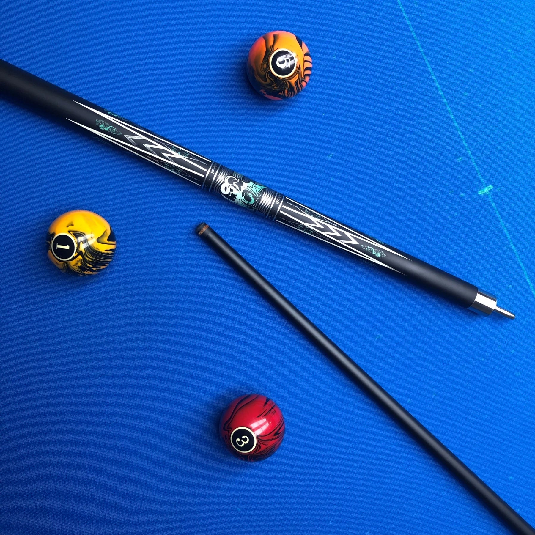 Pool cue and balls on a blue felt surface