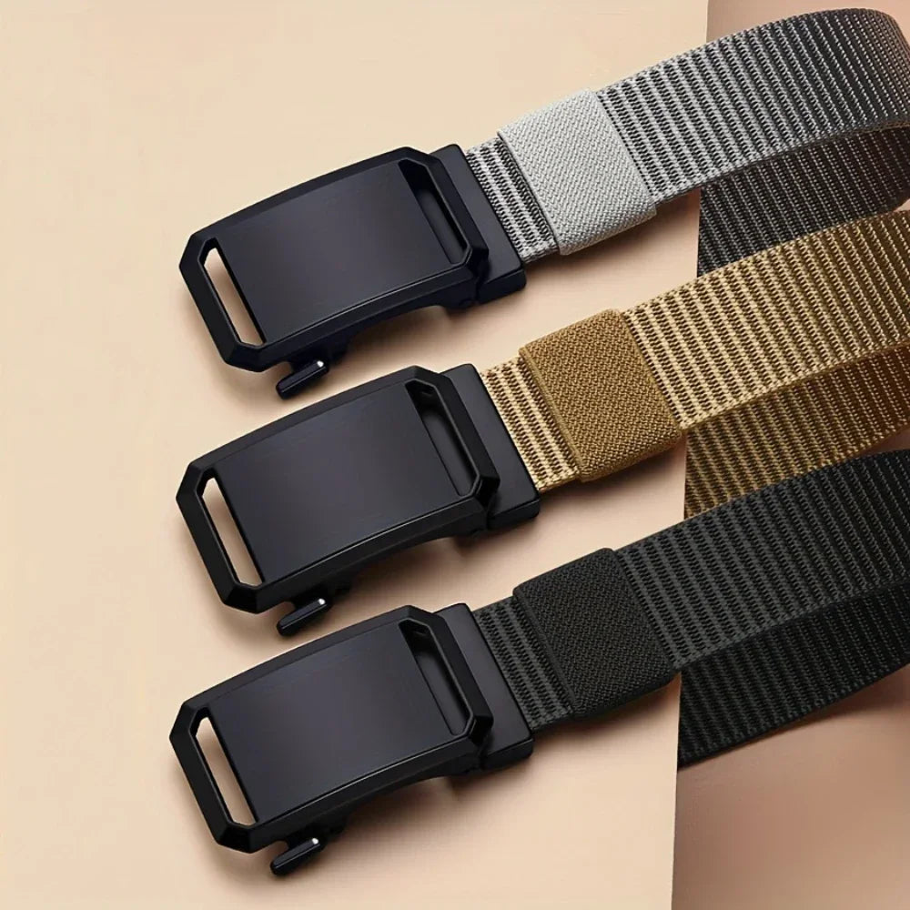 Three belts with black buckles on a beige background
