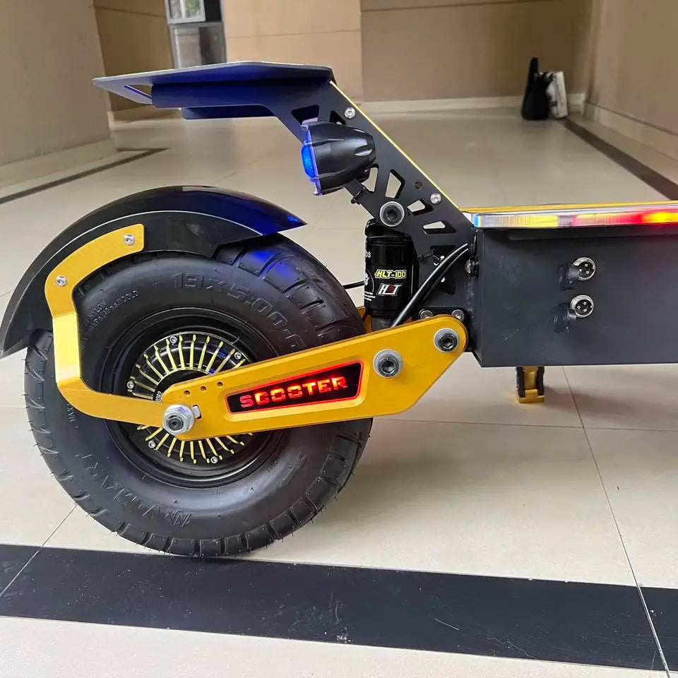 Close-up of a scooter wheel with visible branding on a tiled floor.