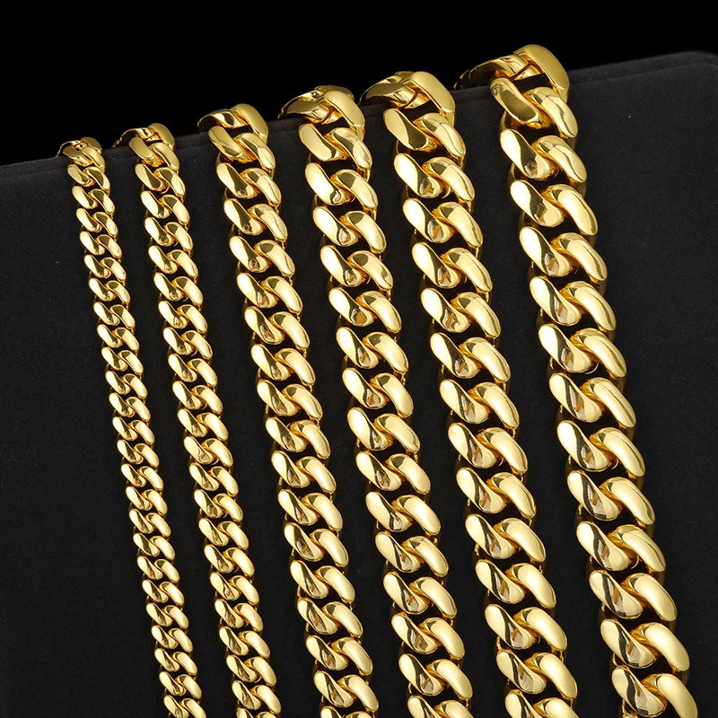 Gold chain necklaces on a black background