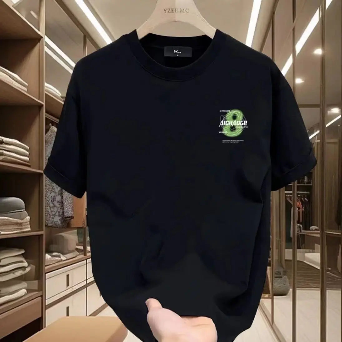 Black t-shirt with a green logo on a hanger in a clothing store.